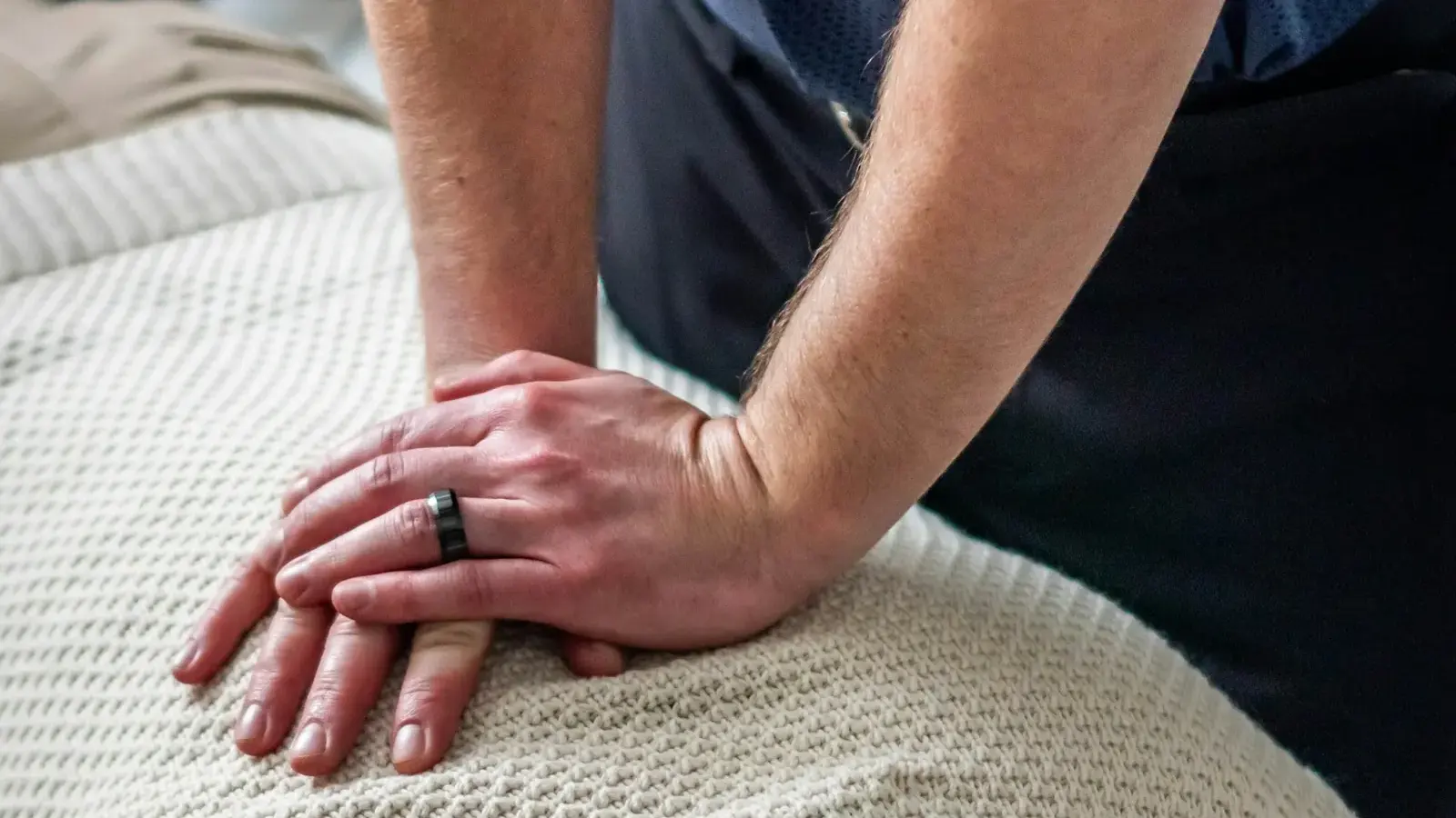Chiropractor's hands positioned on a patient's upper back during an adjustment
