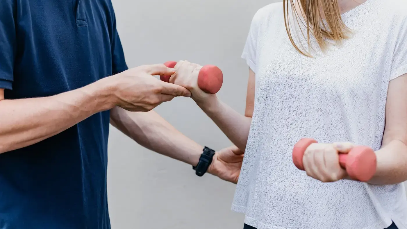 Physiotherapist guiding a patient through a strengthening exercise