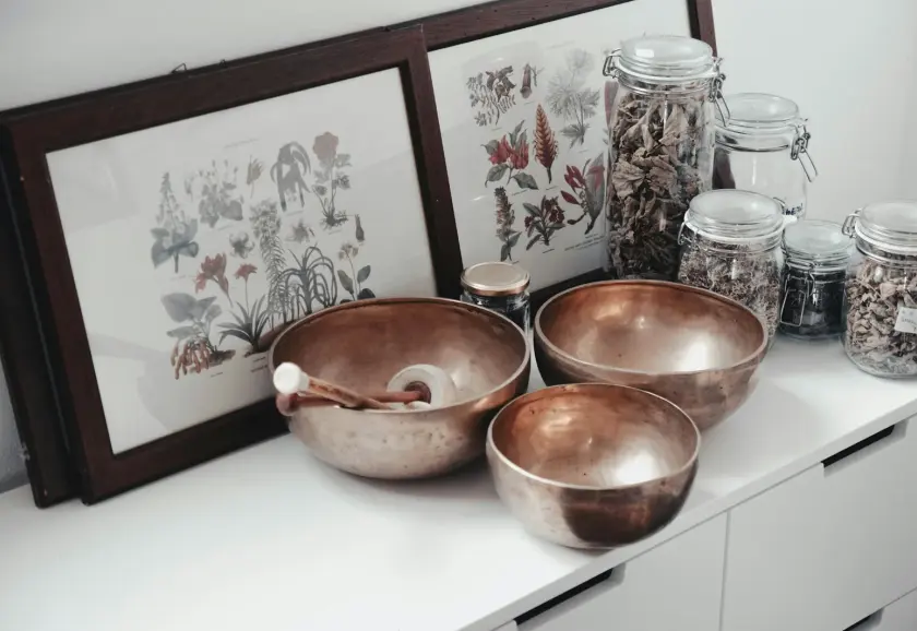 Herbal medicine jars and copper bowls in a naturopathic clinic